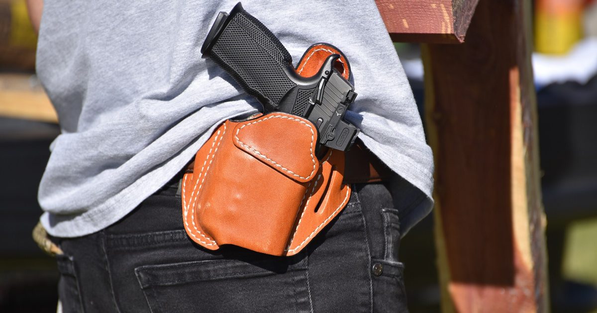 Open carry handgun in leather belt holster.jpg